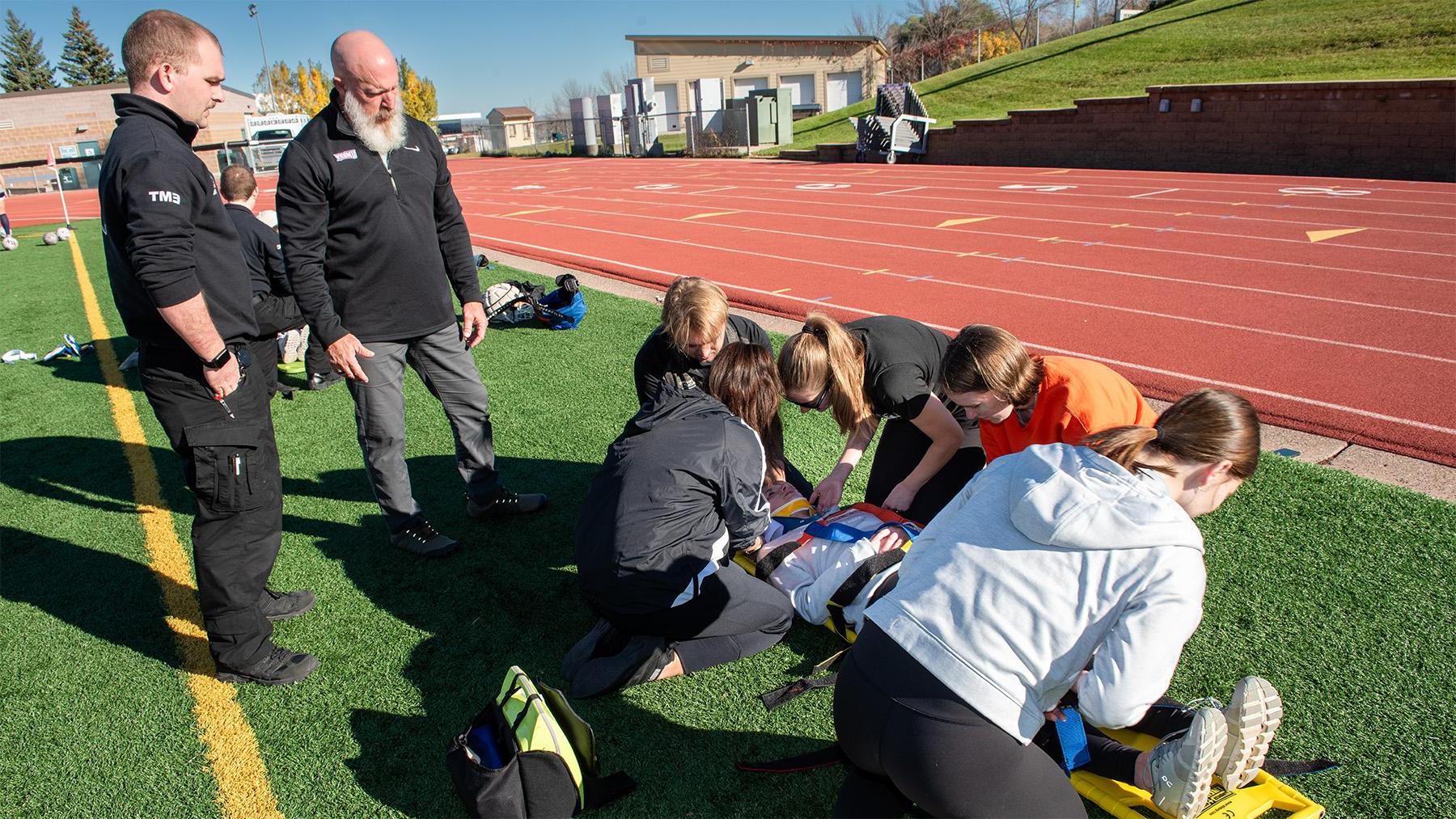 Athletic Training Students practicing on the field